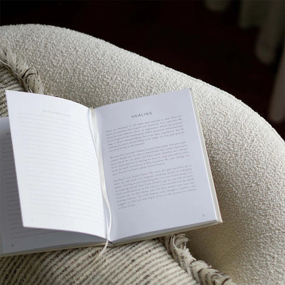 Open journal on a textured surface with 'HEALING' visible,  for self-reflection, mindfulness, mental health support, and gratitude.